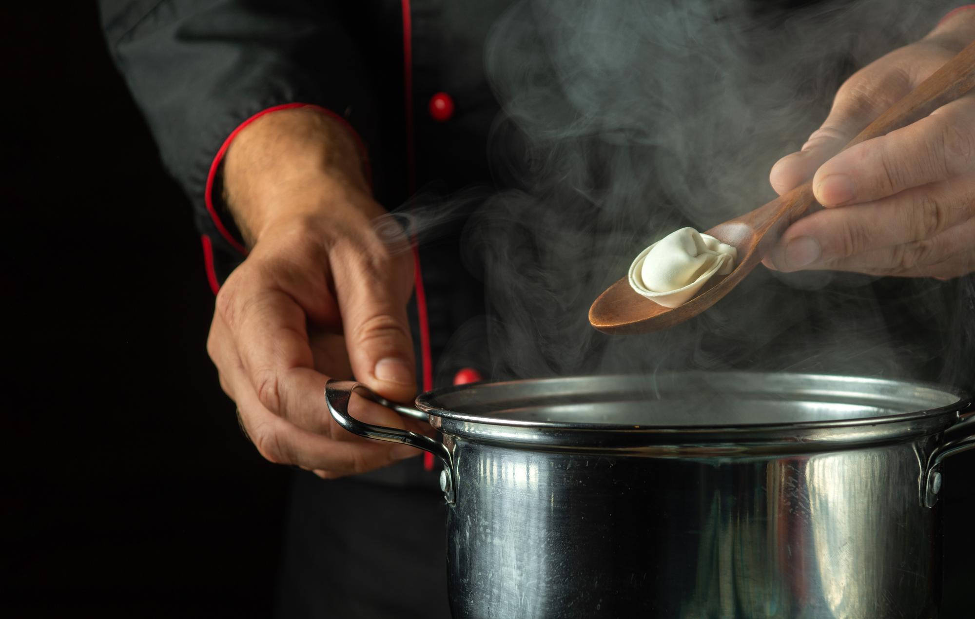 Close-up hands preparing sauce